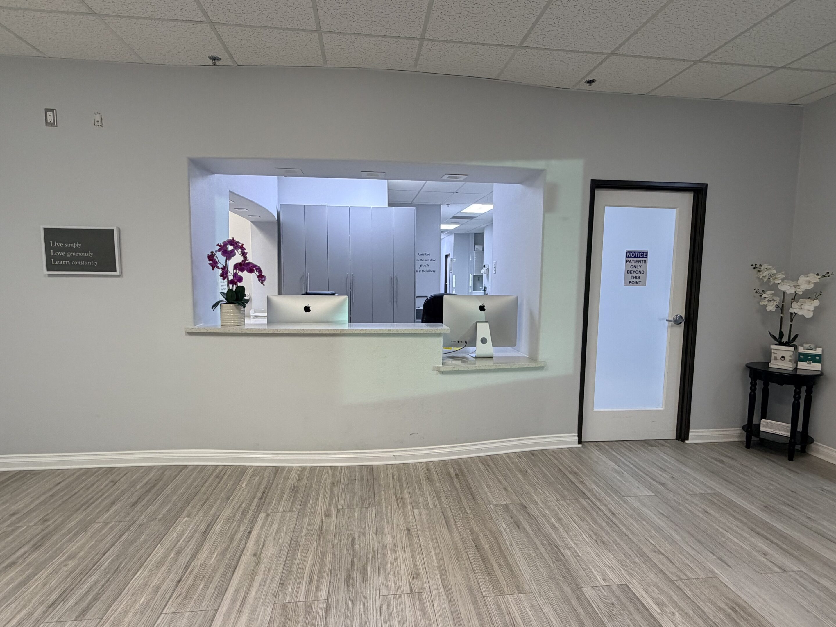 Reception area with a window counter and a door labeled 'Exit'.